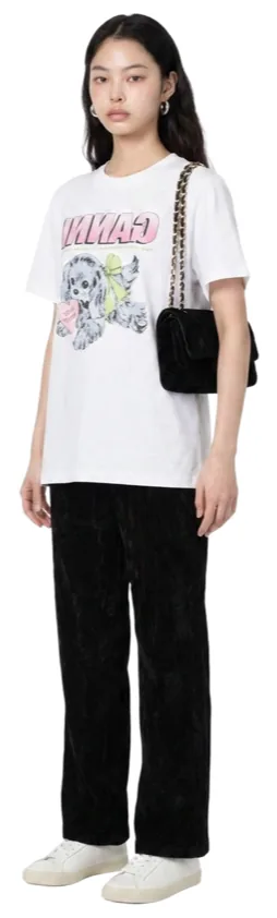 A white graphic tee with black wide-leg trousers and white sneakers.