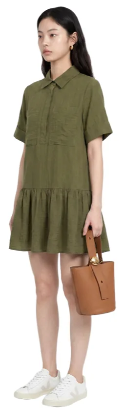 An olive shirt dress with white sneakers and a tan bucket bag.