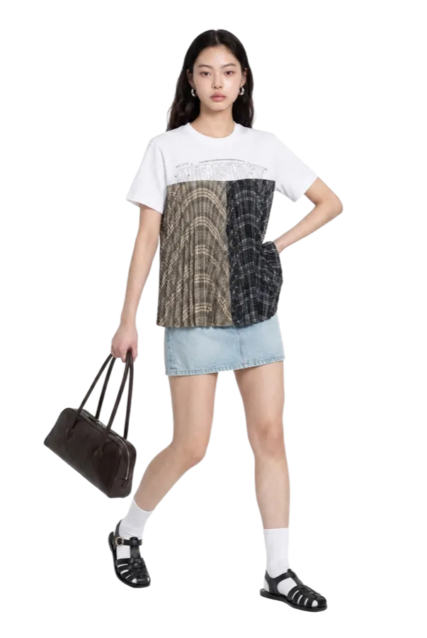The same printed tee worn with a denim mini skirt.