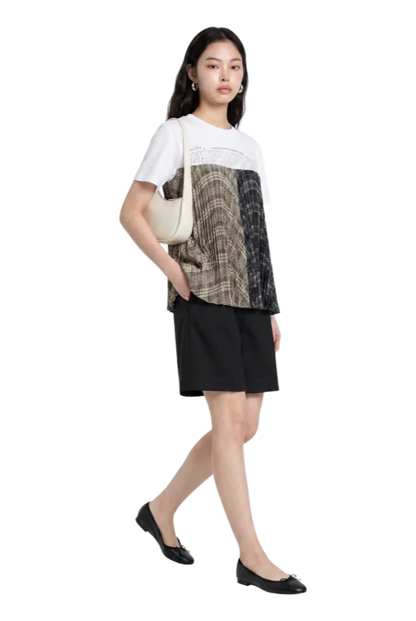 The same printed tee worn with black trousers and a tote.